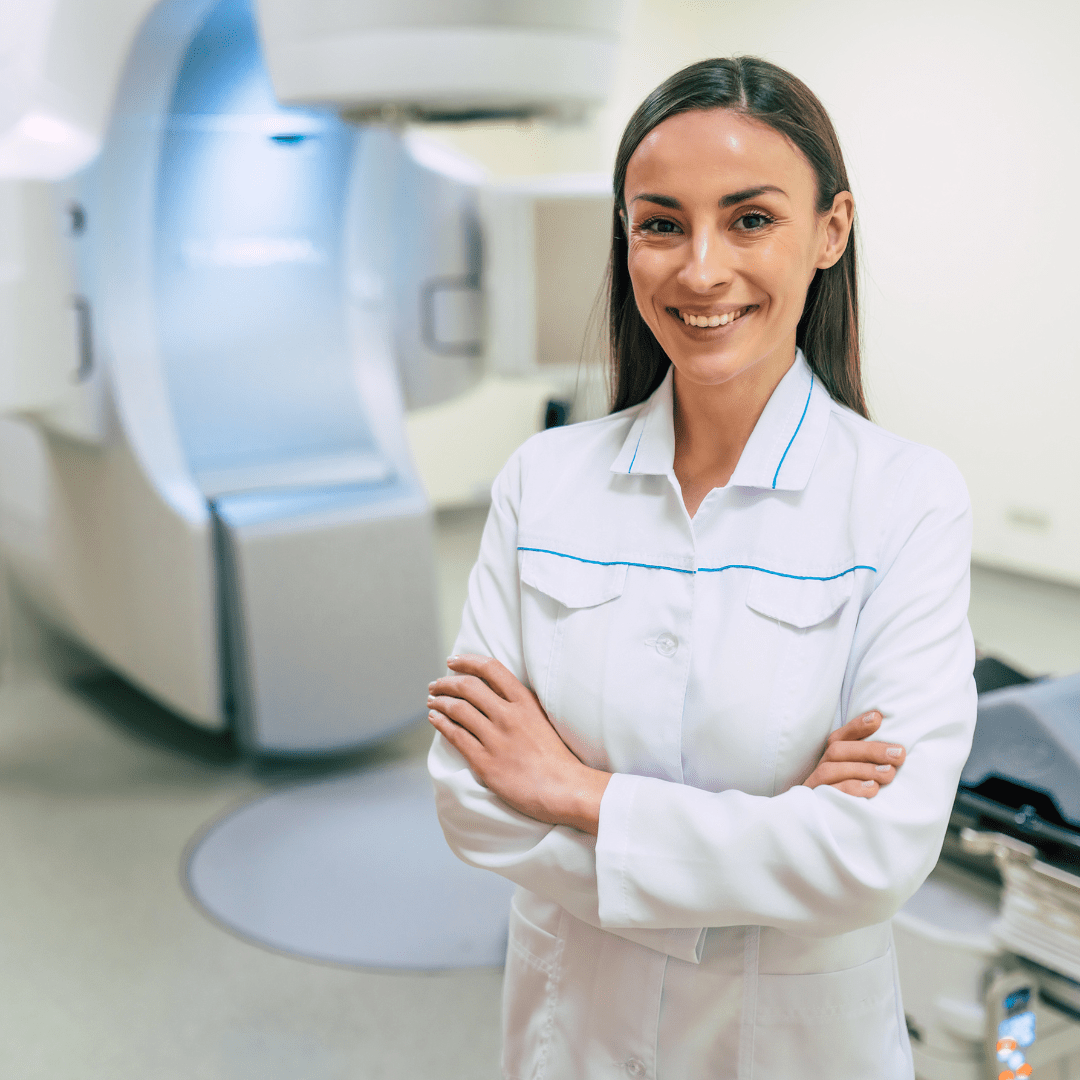 nurse standing in front of diagnostic equipment